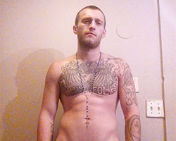 photo of a shirtless paul dimick emphasising tattoos